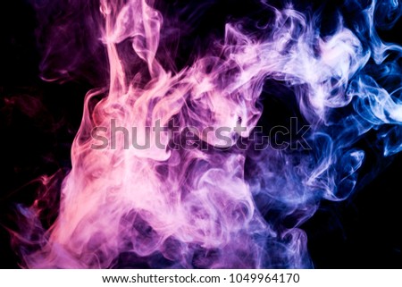 Pink, yellow and purple  cloud of smoke of  black isolated background. Background from the smoke of vape
