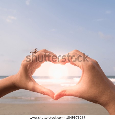 The hand of a woman with the sun shines through. Love and Valentine concept.