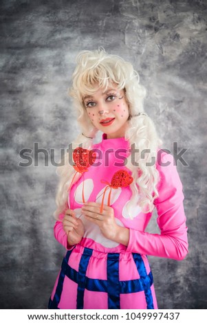 Cheerful young girl in pink colorful  costume of puppy Children's animator, costume show, carnival. Colorful picture for a poster, a funny card, an invitation to the party.