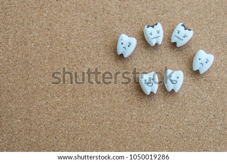 cute teeth cartoon of health and decayed icon on wooden cork background