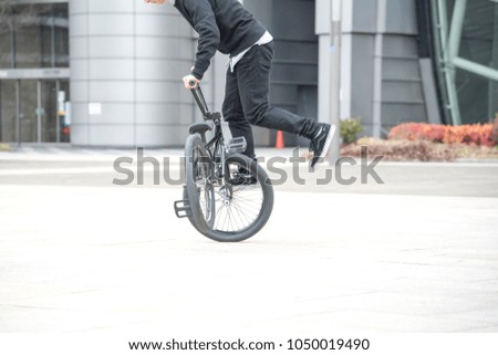 Men do not see the face is playing with bmx bike on Texture background
