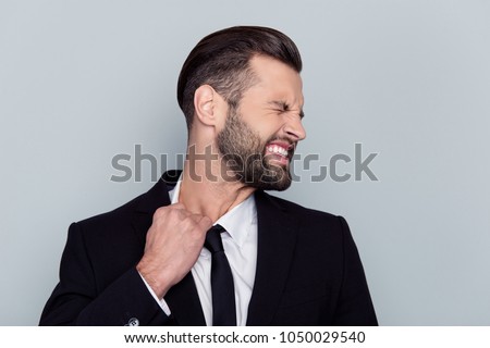 Entrepreneur trainee health care staff people pressure concept. Profile side view close up portrait of exhausted frustrated sad upset unhealthy banker trying to tear tie isolated on gray background Royalty-Free Stock Photo #1050029540