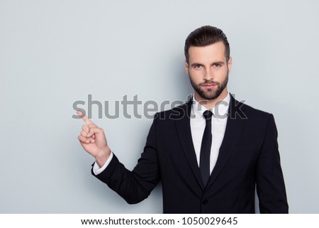 Portrait of authoritative strict manful bossy serious angry confident focused expert assistant wearing white shirt black tie pointing on empty blank copy space copyspace isolated on gray background