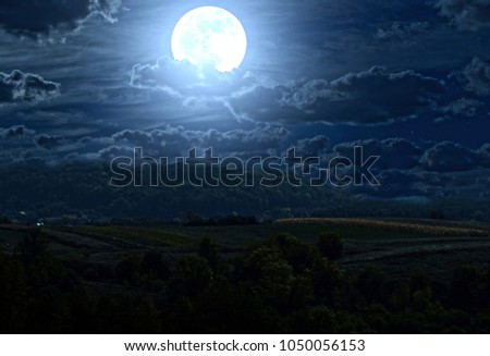 A fairy full moon over the hills
