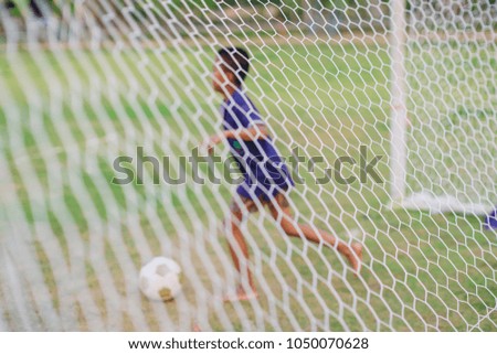 Blur background picture for concept of sport : soccer football player (boy) that activity good for exercise.