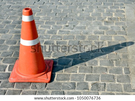 The orange cone is an object of the forbidden parking where the orange cone is located.It is located in front of the church in Thai temple to prohibit the car parked in this area.