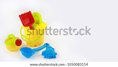Colorful sand castle toys - bucket, shovel, spoon, fork and spade. Kids education concept with copyspace

