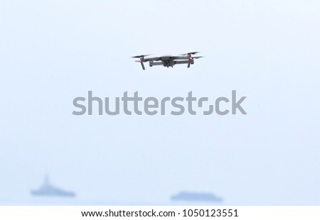 Drone flying during the day in field.