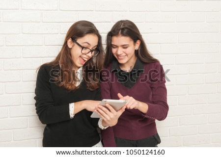 girlfriends are looking at the tablet