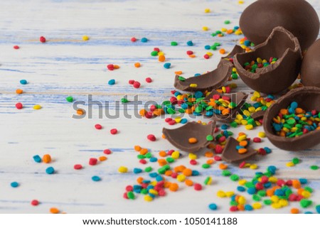 Easter Chocolate Eggs, Multicolored Sweets on the Old White Wooden Background. Easter concept.