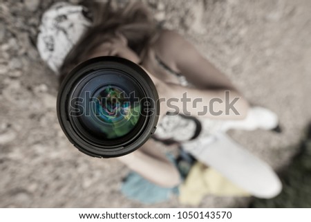 Girl taking pictures lying on the ground