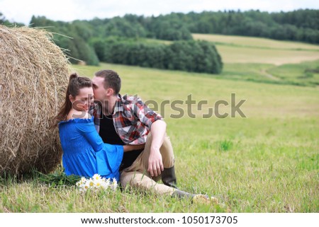 couple in love in a village field at sunset
