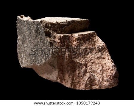 Single natural stone with selective focus on texture details isolated on black background