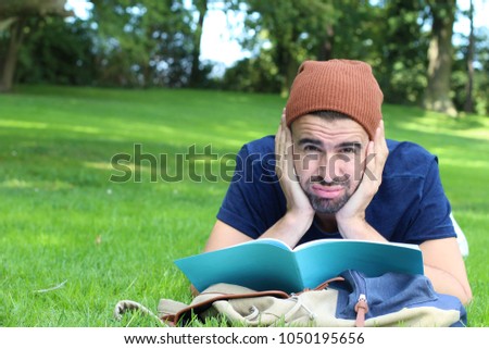 Frustrated student with his notebook on campus