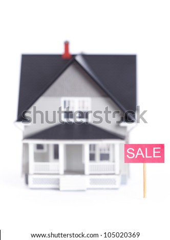 Real estate concept - house architectural model with sale sign, isolated