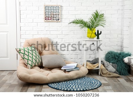 Modern stylish room interior with tropical leaves in glass vase