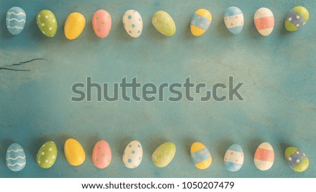 Colorful easter eggs on wooden pastel color background with space.
