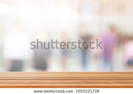 empty brown wooden table and Coffee shop blur background with bokeh image, for product display montage has Copy space available as a Background for the Presentation of Advertising.