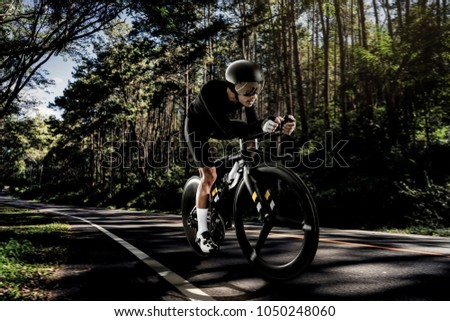Asian men are cycling "time trial bike" in the morning Royalty-Free Stock Photo #1050248060