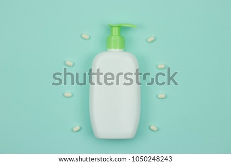 Poster template with place for text and blank cosmetic bottle on the blue background
