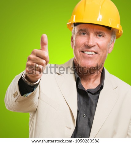 Happy Architect Showing Thumb Up Sign against a green background