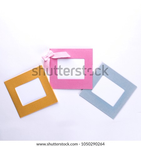 Square multicolor frames with pink bow and isolated on white background