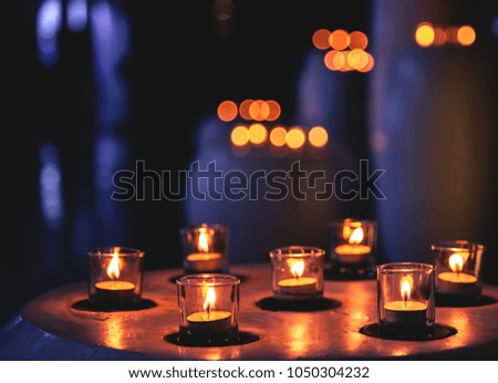 Some candles in a row in spa zone for relaxing time. It is late night.
