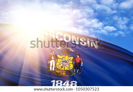 flag of State of Wisconsin against the blue sky with sun rays