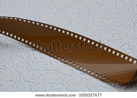 A portion of a brown film on a gray surface