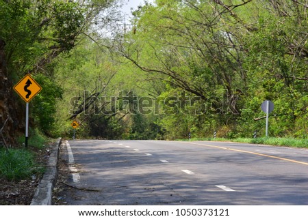 sign road sharp curves in country side Thailand.