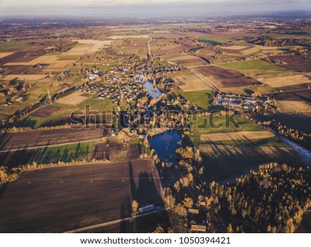 Aerial Drone Photograph of a Meadows Surrounded with Beautiful Autumn Colors of the Forests - Vintage look edit