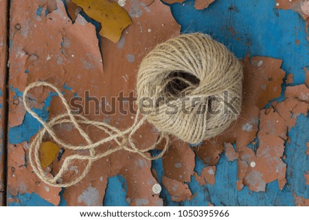 A roll of string isolated on a old wooden background