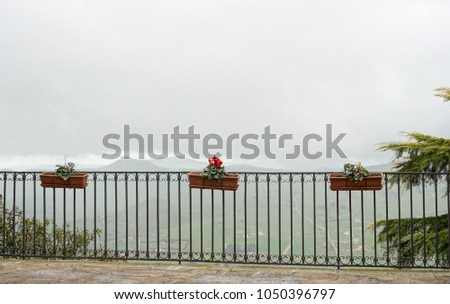 Balcony with a panoramic view of the low clouds located in the small Sicilian town Gangi.