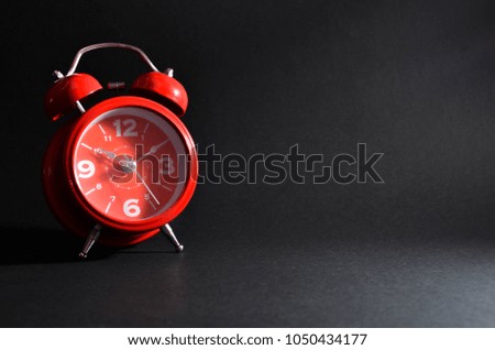 Alarm clock on dark background. 