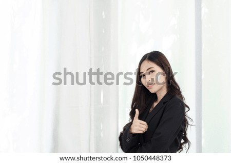 Asian women In black suit  and smiling happily at work in the morning,Black spots on the face of a woman caused by sunlight. Cause cotton or freckles.