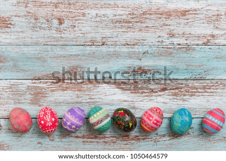 Colorful Easter egg side border against a rustic wood Vintage pastel background