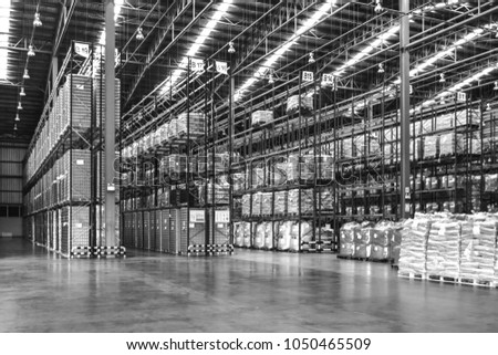 Warehouse industrial and logistics companies. Commercial warehouse. Huge distribution warehouse with high shelves. Bottom view. Black and white. Royalty-Free Stock Photo #1050465509