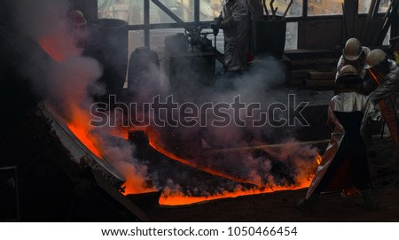 Classic technology of bell producing with melting steel to the ground. Casting new bell for Ebersmunster church in Alsace, France Royalty-Free Stock Photo #1050466454