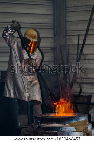 Classic technology of bell producing with melting steel to the ground. Casting new bell for Ebersmunster church in Alsace, France Royalty-Free Stock Photo #1050466457