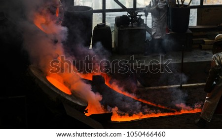 Classic technology of bell producing with melting steel to the ground. Casting new bell for Ebersmunster church in Alsace, France Royalty-Free Stock Photo #1050466460