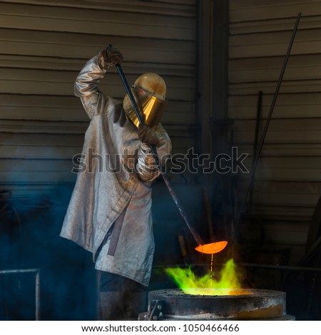 Classic technology of bell producing with melting steel to the ground. Casting new bell for Ebersmunster church in Alsace, France Royalty-Free Stock Photo #1050466466