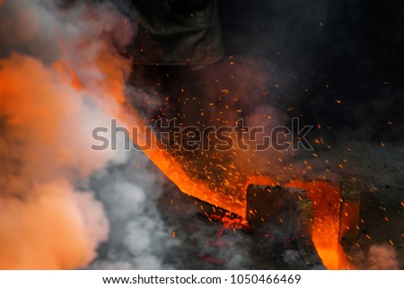 Classic technology of bell producing with melting steel to the ground. Casting new bell for Ebersmunster church in Alsace, France Royalty-Free Stock Photo #1050466469