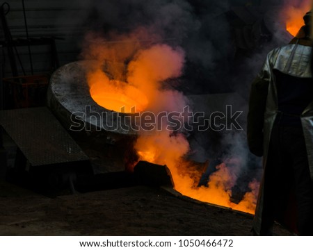 Classic technology of bell producing with melting steel to the ground. Casting new bell for Ebersmunster church in Alsace, France Royalty-Free Stock Photo #1050466472