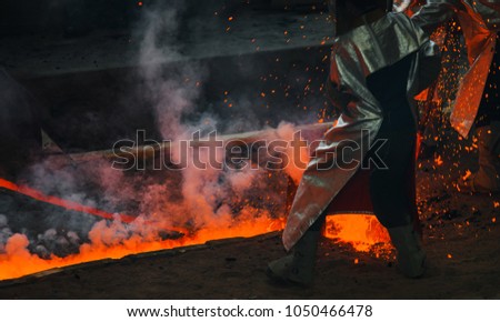 Classic technology of bell producing with melting steel to the ground. Casting new bell for Ebersmunster church in Alsace, France Royalty-Free Stock Photo #1050466478