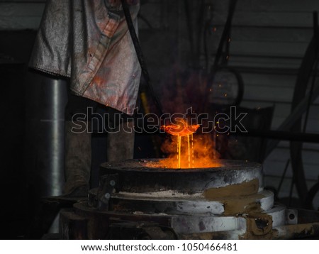 Classic technology of bell producing with melting steel to the ground. Casting new bell for Ebersmunster church in Alsace, France Royalty-Free Stock Photo #1050466481