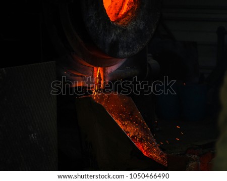 Classic technology of bell producing with melting steel to the ground. Casting new bell for Ebersmunster church in Alsace, France Royalty-Free Stock Photo #1050466490