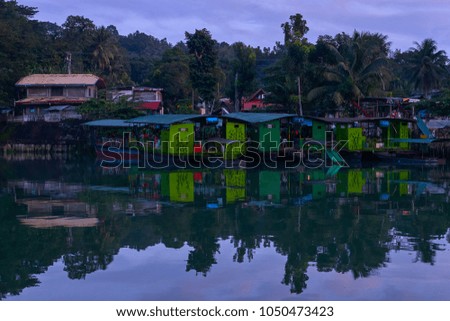 Beautiful scenic sunset evening view on fishing village river