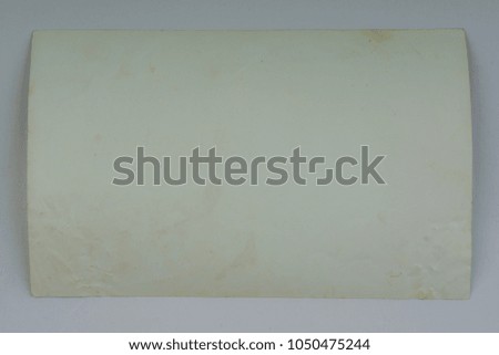 Vintage and antique art concept. Front view of blank old aged dirty photo frame texture with stains and scratches isolated on abstract blurred white background. Detailed closeup studio shot.
