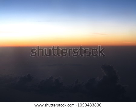 Horizon line of blue sky and clouds with beautiful golden orange sunset time with light sunrise nature, picture from plane.
