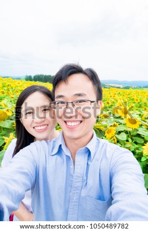 couple selfie happily in Hokkaido SunFlower Field